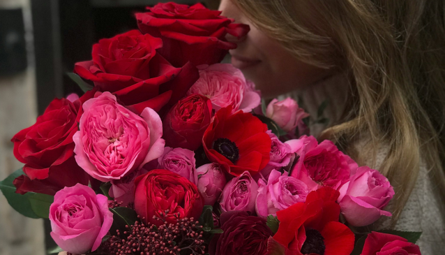 Valentine's day mood boards blog image of a girl holding a bouquet of red and pink flowers